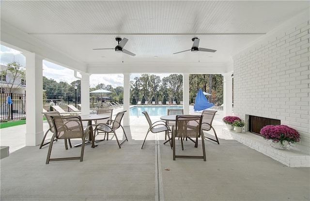 view of patio / terrace featuring a community pool and ceiling fan