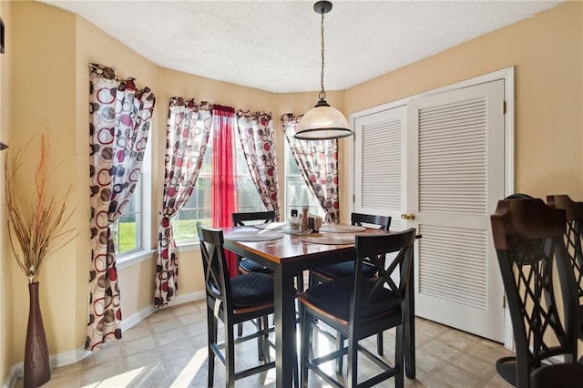 dining area with a textured ceiling