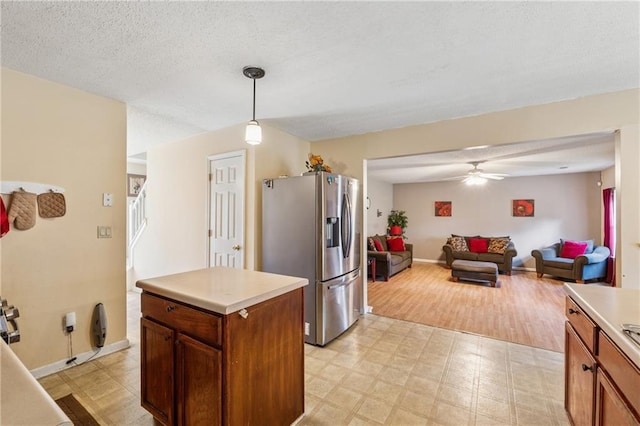 4450 Millenium View Ct, Snellville, GA 30039 - kitchen featuring stainless steel fridge, light flooring, a ceiling fan, open floor plan, and light countertops