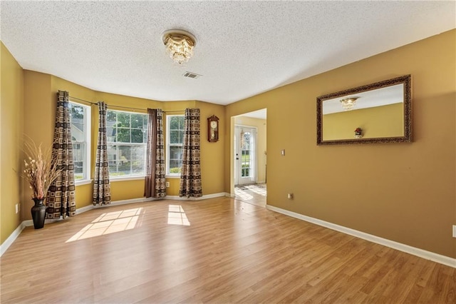 4450 Millenium View Ct, Snellville, GA 30039 - unfurnished room with light wood finished floors and a textured ceiling