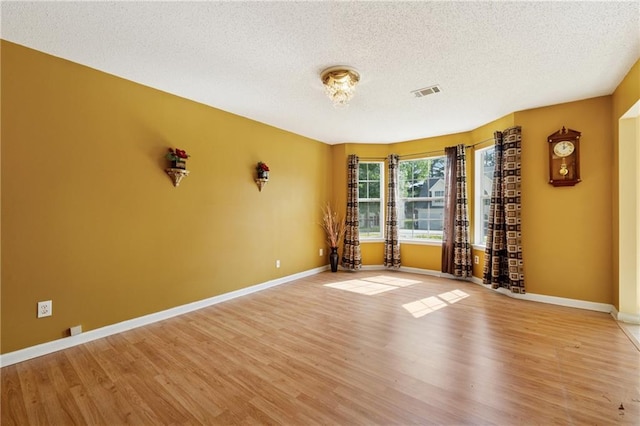 4450 Millenium View Ct, Snellville, GA 30039 - empty room with a textured ceiling and light wood-type flooring