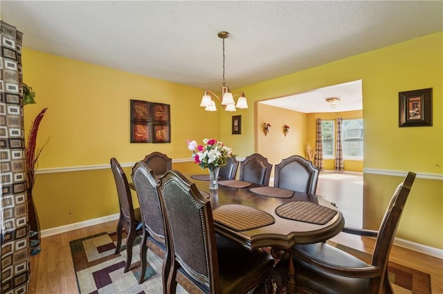 4450 Millenium View Ct, Snellville, GA 30039 - dining room featuring a chandelier and wood finished floors