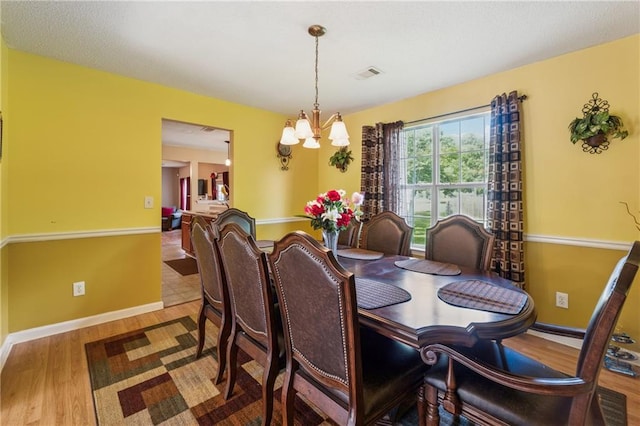 4450 Millenium View Ct, Snellville, GA 30039 - dining area with a chandelier and wood finished floors