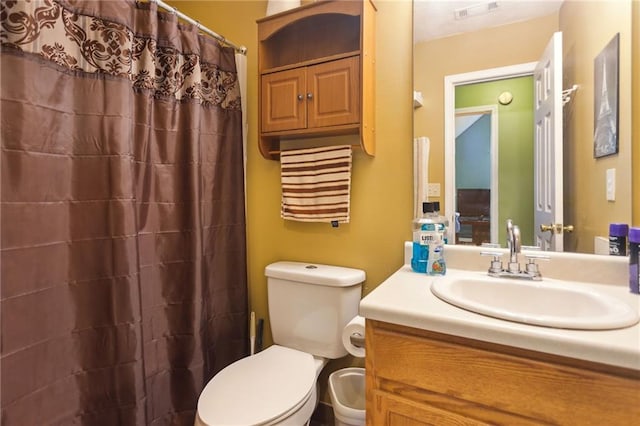 bathroom with vanity, toilet, and walk in shower