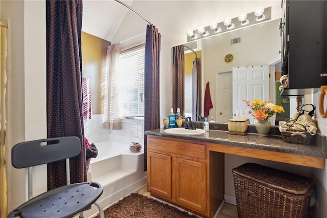 bathroom featuring vanity, lofted ceiling, and a tub to relax in