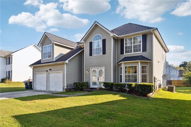 view of front of house featuring french doors, a garage, and a front lawn