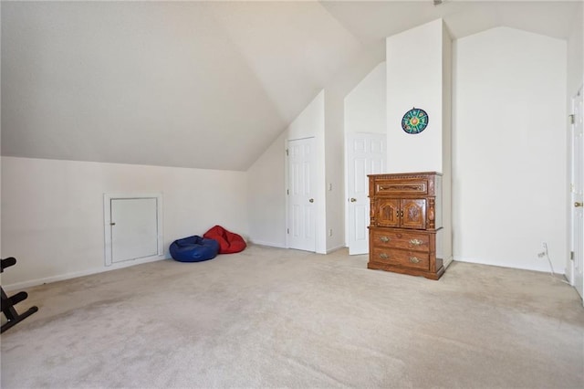 bonus room with light carpet and vaulted ceiling