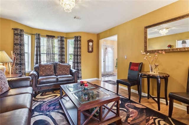 living room with a chandelier and wood-type flooring