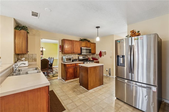 4450 Millenium View Ct, Snellville, GA 30039 - kitchen featuring stainless steel appliances, brown cabinets, light countertops, decorative backsplash, and a textured ceiling