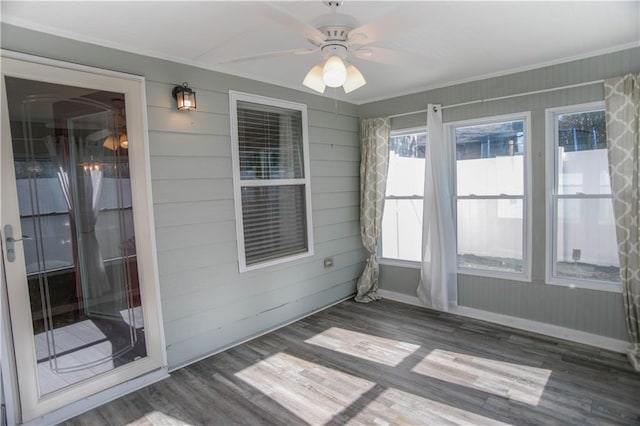 unfurnished sunroom with ceiling fan