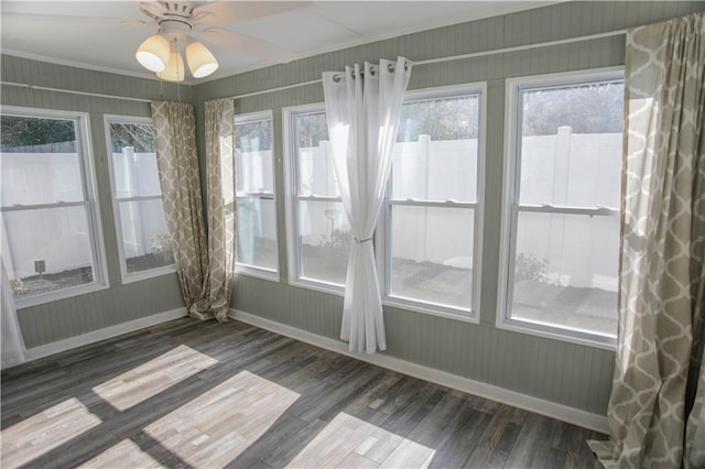 unfurnished sunroom with a ceiling fan