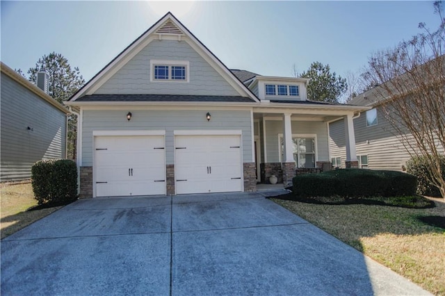 craftsman-style house with an attached garage, covered porch, and concrete driveway