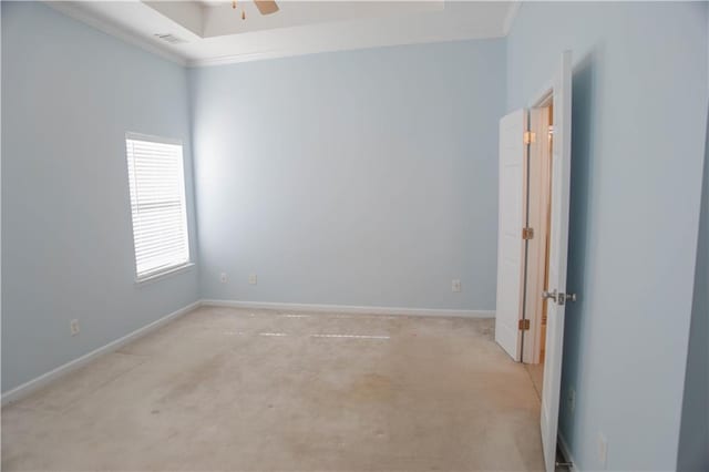 empty room with ceiling fan, light carpet, visible vents, baseboards, and ornamental molding