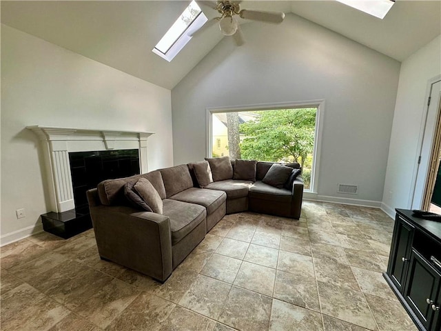 810 Doe Hill Ln, Roswell, GA 30075 - living room featuring a skylight, high vaulted ceiling, ceiling fan, a fireplace with raised hearth, and light stone finish flooring
