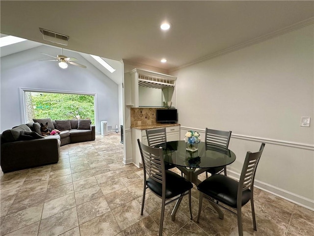 810 Doe Hill Ln, Roswell, GA 30075 - dining space featuring a skylight, a ceiling fan, recessed lighting, crown molding, and light stone finish floors