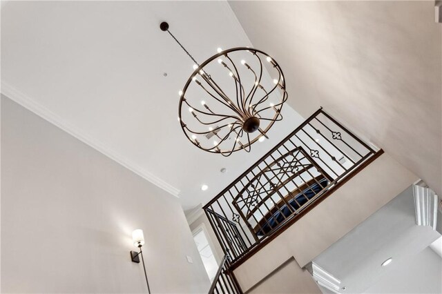 3280 Stillhouse Ln SE Unit 401, Atlanta, GA 30339 - staircase with ornamental molding, a towering ceiling, and a chandelier