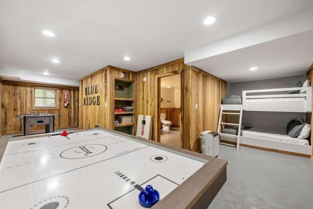 recreation room with wooden walls