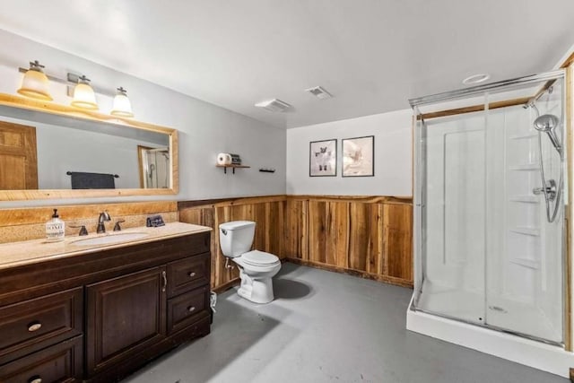 bathroom with vanity, wooden walls, toilet, walk in shower, and concrete floors