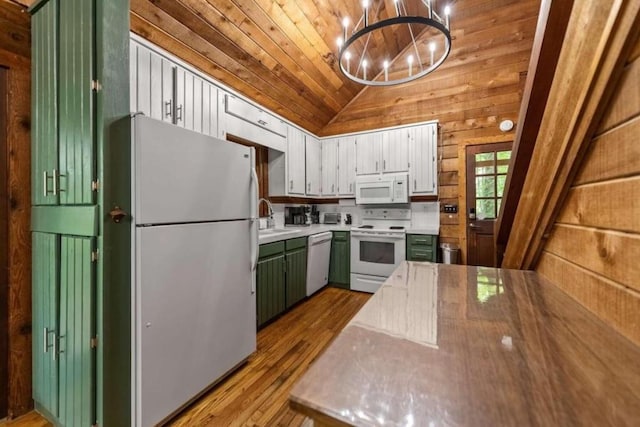 kitchen with lofted ceiling, white appliances, wooden ceiling, hanging light fixtures, and white cabinetry