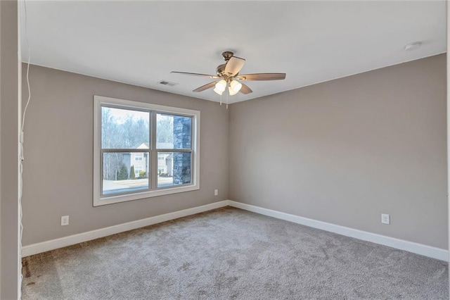 carpeted spare room with ceiling fan