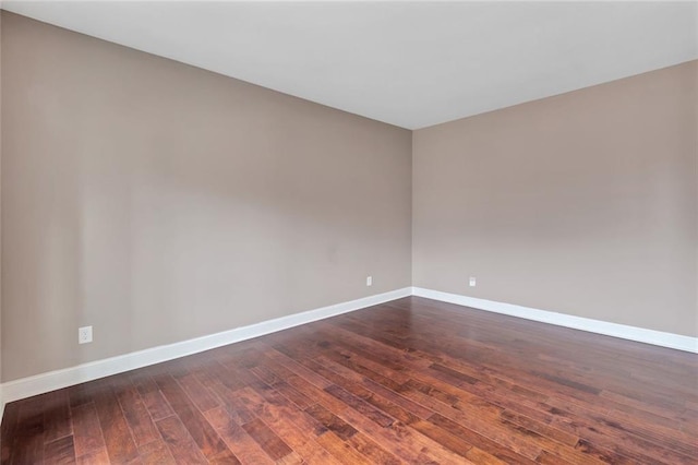 empty room with dark wood-type flooring