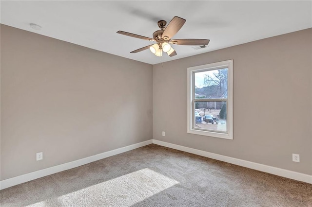 unfurnished room featuring a ceiling fan, carpet, visible vents, and baseboards