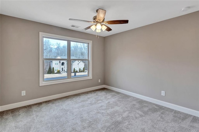 empty room featuring light carpet and ceiling fan