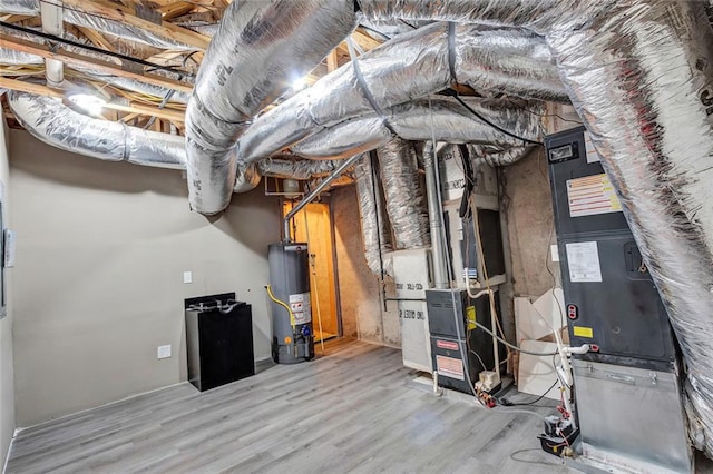 utility room with heating unit and water heater