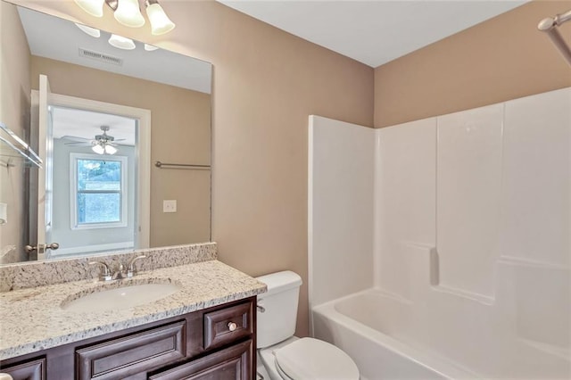 full bathroom with bathtub / shower combination, vanity, and toilet