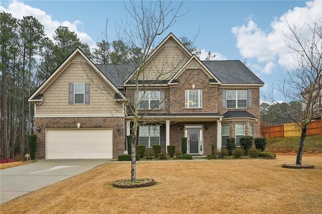 craftsman inspired home featuring a garage and a front lawn