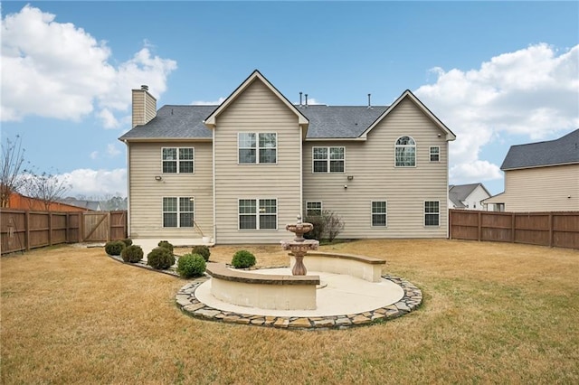 rear view of house with a patio and a yard