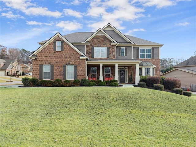 view of front of property with covered porch and a front yard