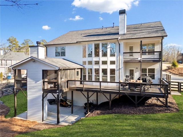 back of house with a patio area and a lawn