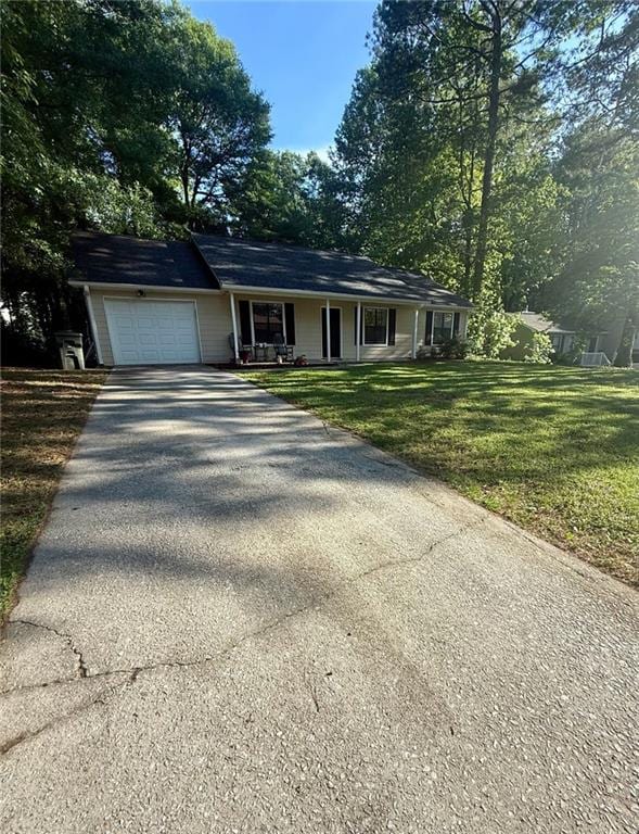 2661 Throatlatch Ln SW, Marietta, GA 30064 - ranch-style house with covered porch, driveway, a garage, and a front lawn