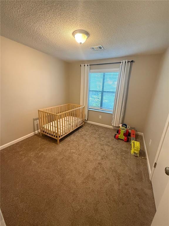 2661 Throatlatch Ln SW, Marietta, GA 30064 - unfurnished bedroom with carpet, a textured ceiling, baseboards, and a crib