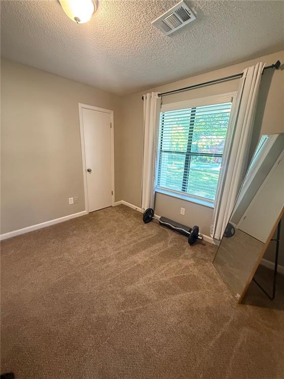 2661 Throatlatch Ln SW, Marietta, GA 30064 - carpeted empty room with a textured ceiling and baseboards