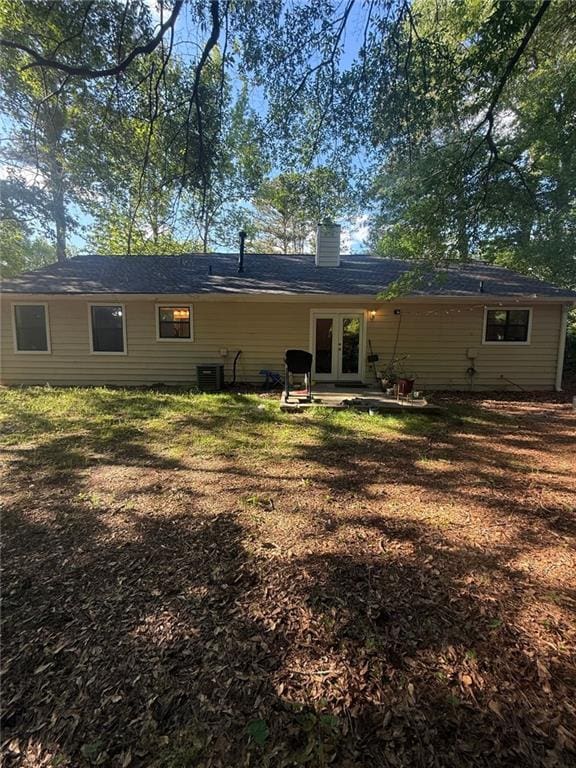 2661 Throatlatch Ln SW, Marietta, GA 30064 - back of house with a chimney, a patio, central AC, and french doors