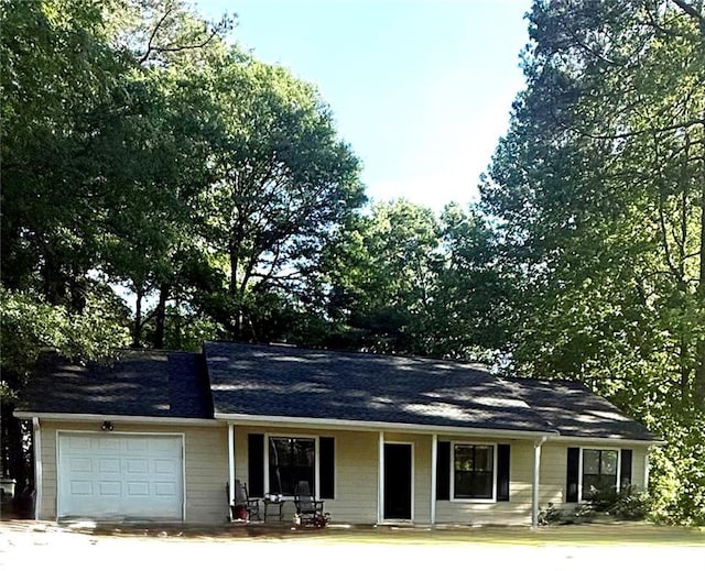2661 Throatlatch Ln SW, Marietta, GA 30064 - ranch-style house with a garage, a shingled roof, and covered porch