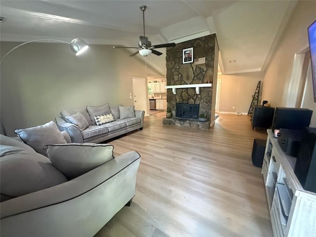 2661 Throatlatch Ln SW, Marietta, GA 30064 - living room featuring ceiling fan, vaulted ceiling, wood finished floors, a stone fireplace, and baseboards
