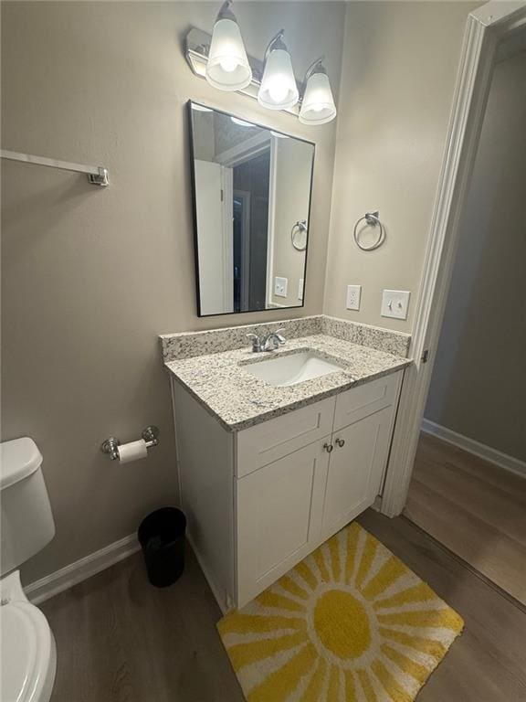2661 Throatlatch Ln SW, Marietta, GA 30064 - half bathroom featuring toilet, wood finished floors, vanity, and baseboards