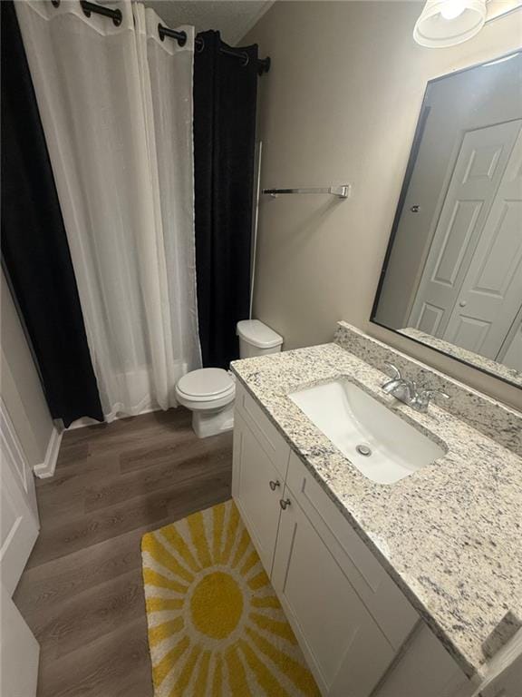 2661 Throatlatch Ln SW, Marietta, GA 30064 - full bathroom featuring vanity, wood finished floors, toilet, and curtained shower