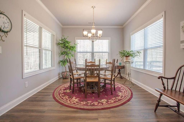 dining space with a notable chandelier, a healthy amount of sunlight, dark hardwood / wood-style flooring, and crown molding