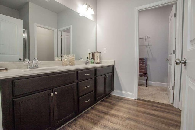 bathroom featuring dual sinks, hardwood / wood-style floors, and oversized vanity