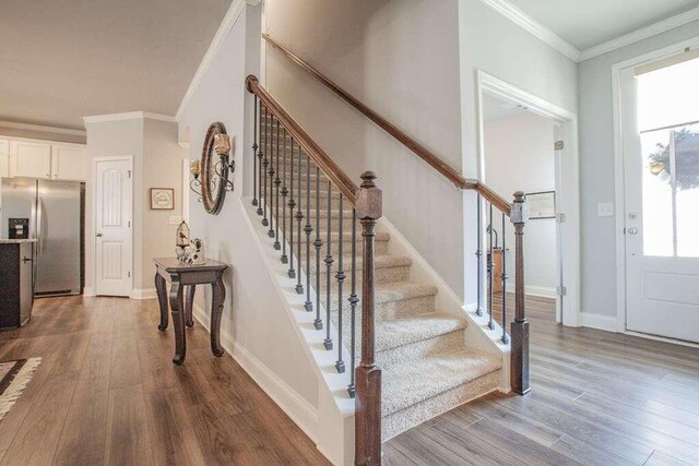 interior space featuring ornamental molding and hardwood / wood-style floors