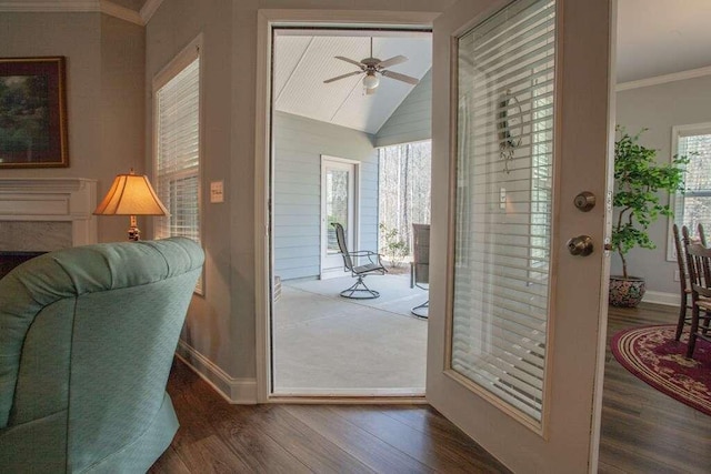 doorway to outside with dark wood-type flooring, ceiling fan, crown molding, and vaulted ceiling