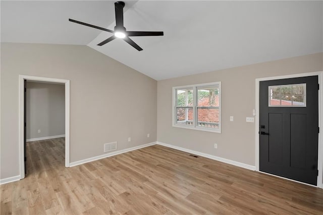 foyer entrance featuring ceiling fan, light hardwood / wood-style flooring, and vaulted ceiling