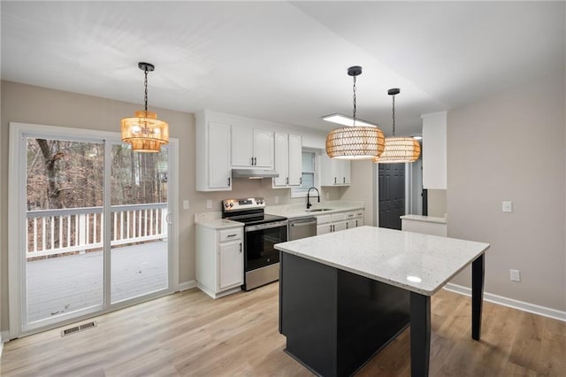 kitchen featuring pendant lighting, an inviting chandelier, stainless steel appliances, and white cabinetry