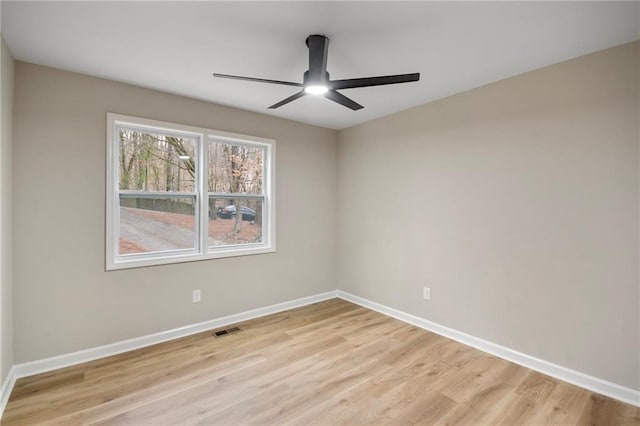 empty room with light wood-type flooring and ceiling fan