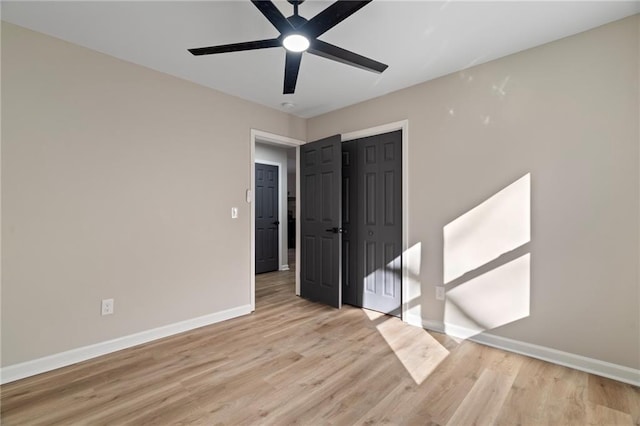 empty room with ceiling fan and light wood-type flooring