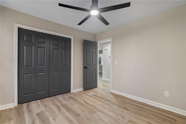 unfurnished bedroom with ceiling fan, a closet, and light hardwood / wood-style floors